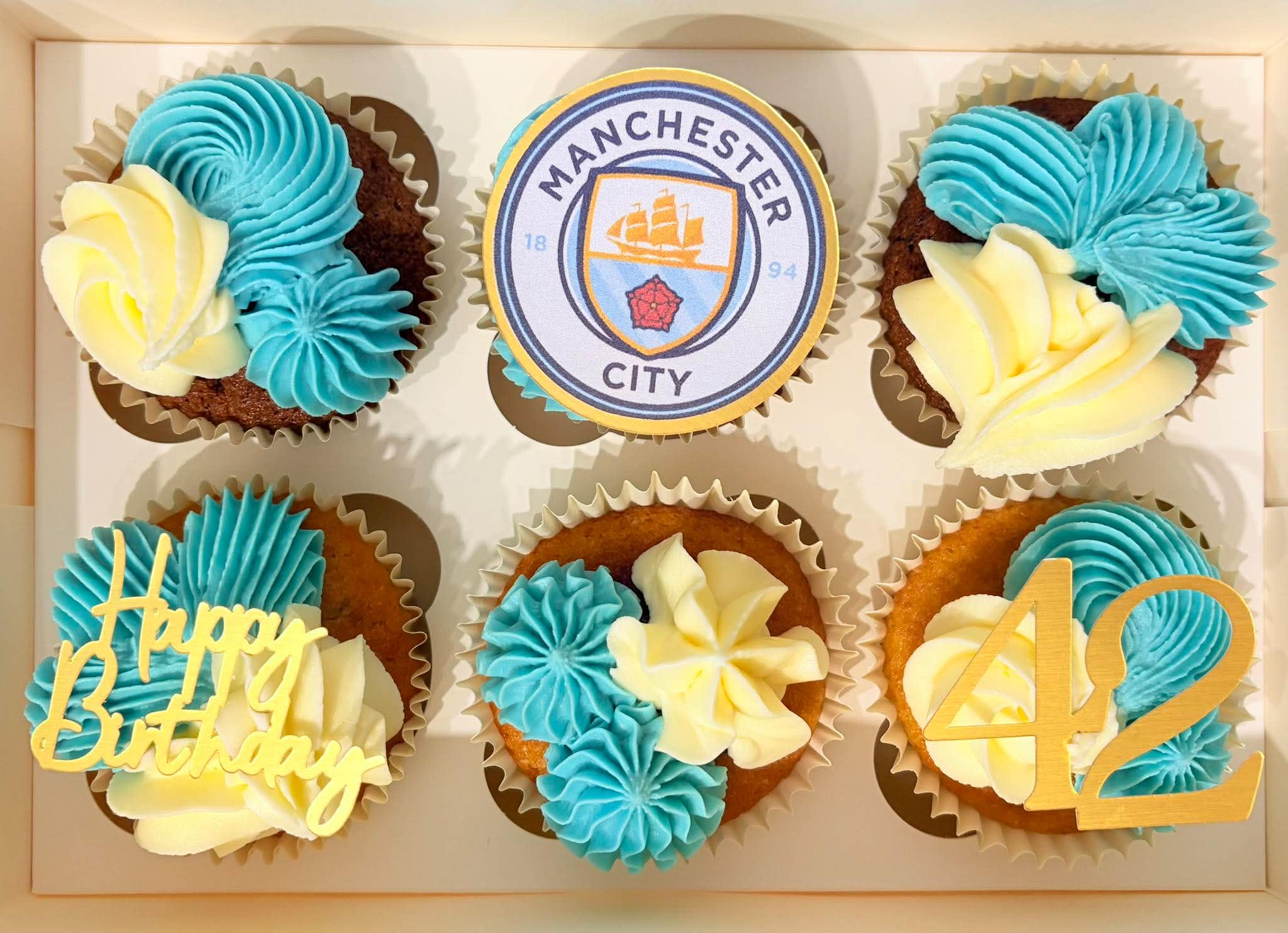 Manchester City themed birthday cupcakes with blue and ivory buttercream