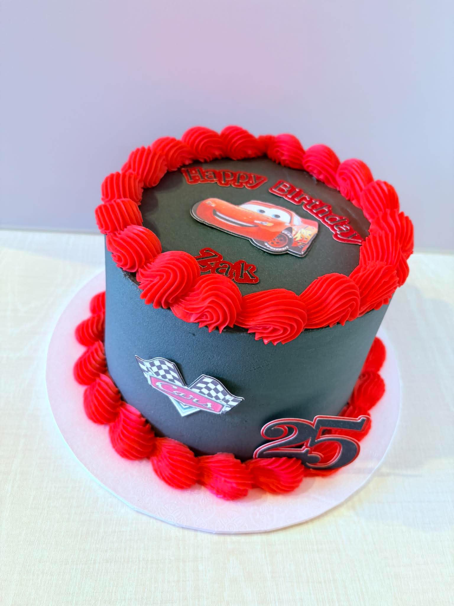 Black and red Lightning McQueen themed birthday cake