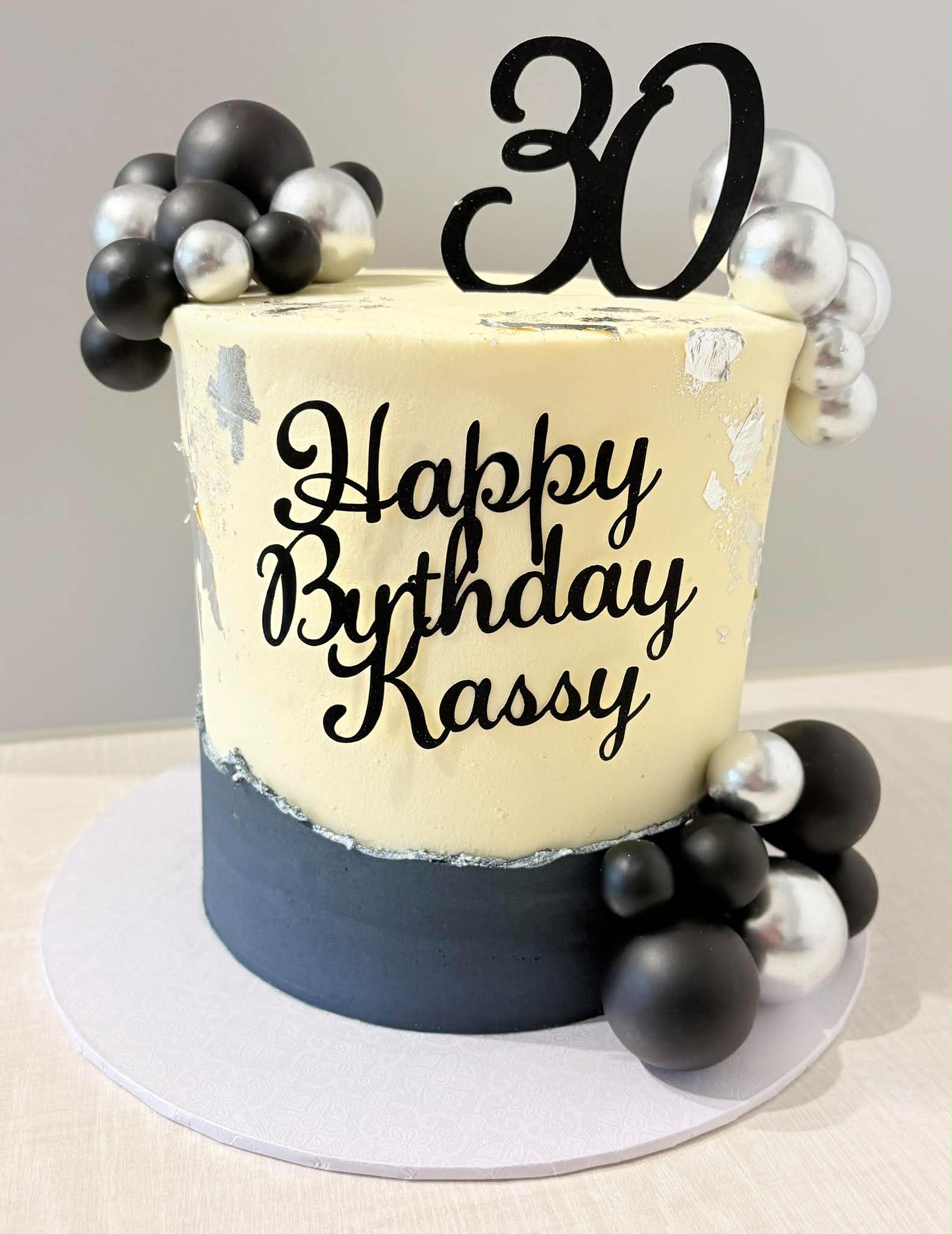 Black, white and silver 30th birthday cake with chocolate spheres