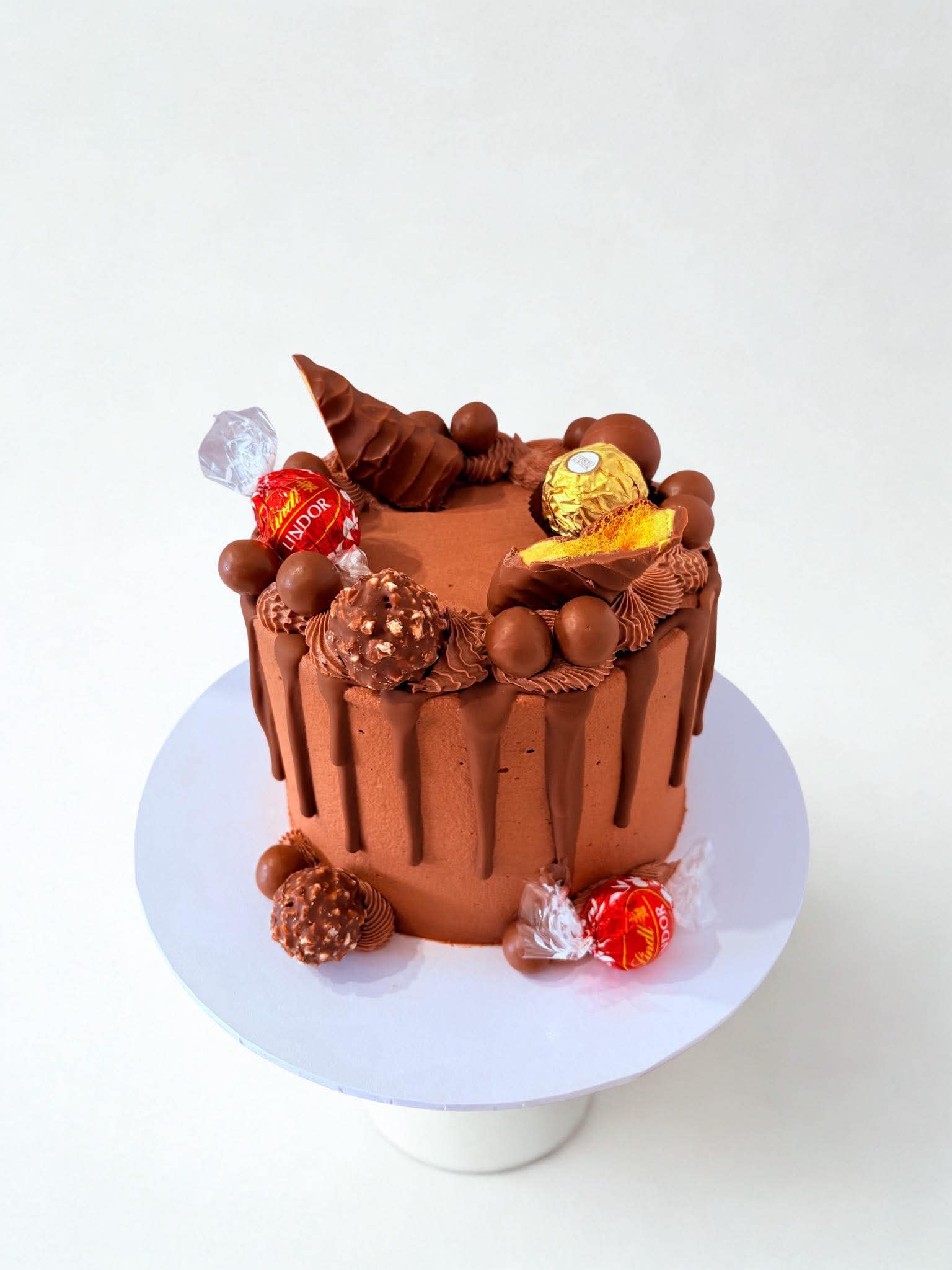 Chocolate drip cake with Lindor truffles and chocolate decorations