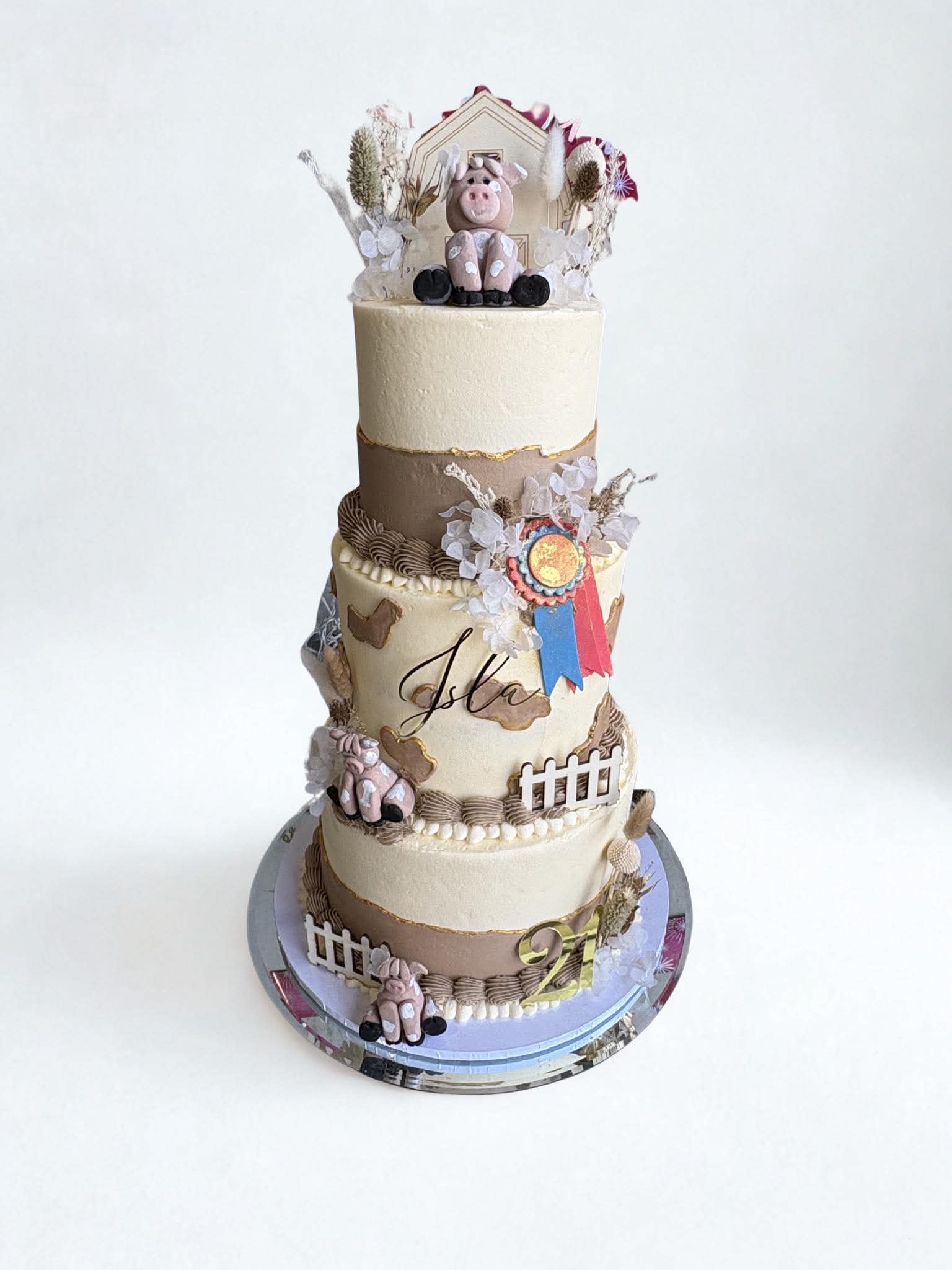 Four-tier farmyard themed birthday cake with animal decorations