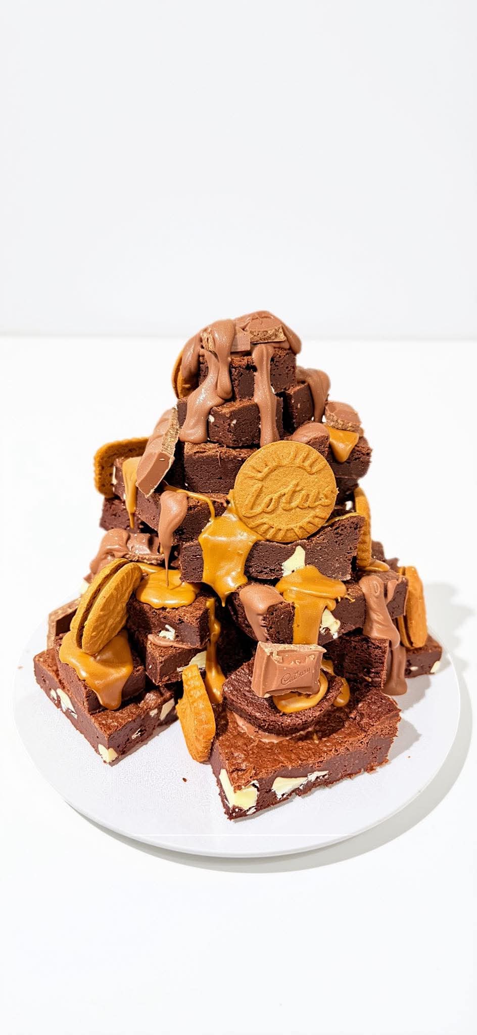 Brownie stack with chocolate, caramel-coloured drizzle and biscuits
