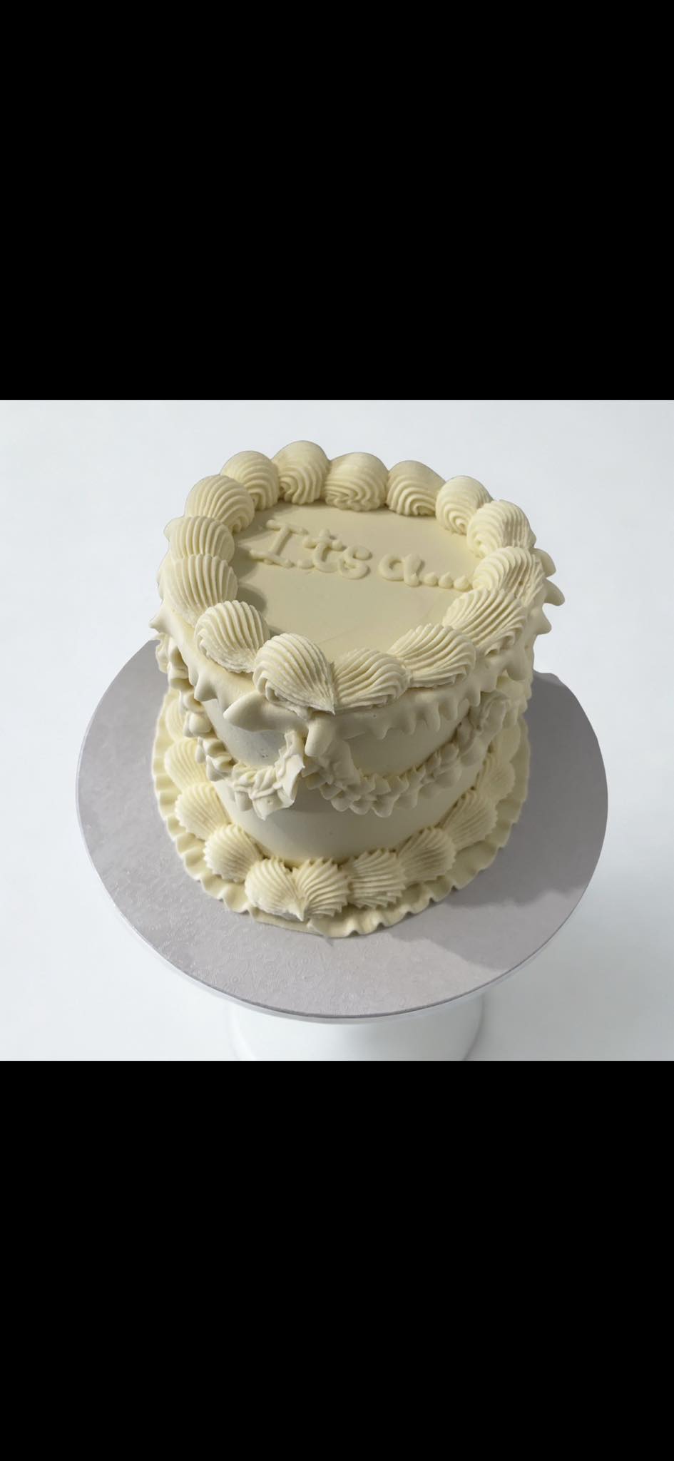 Ivory baby celebration cake with delicate vintage piping