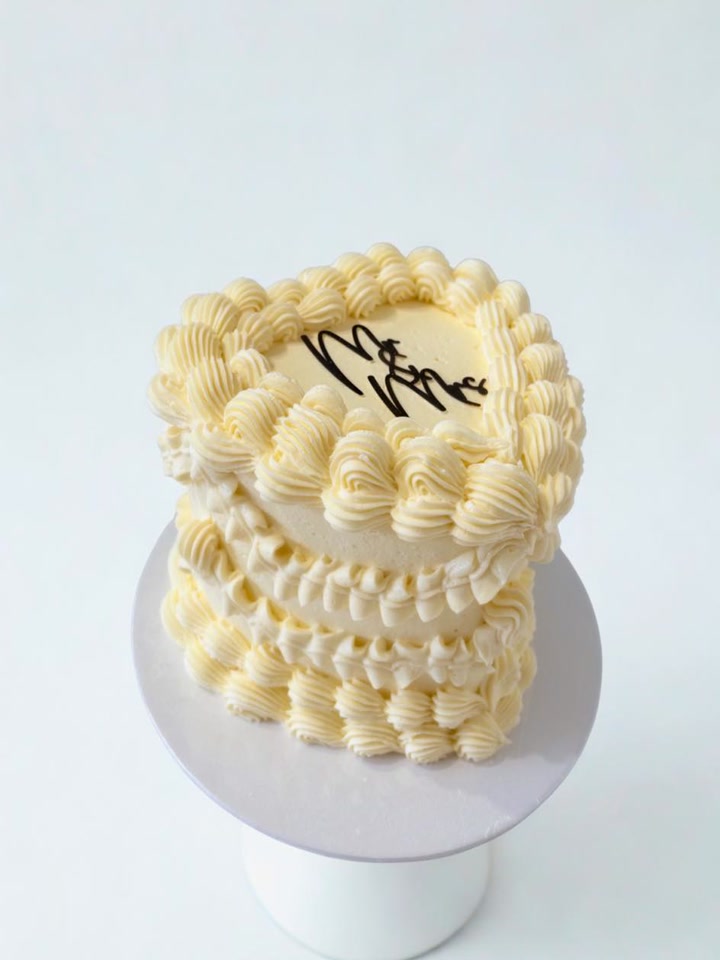 Ivory wedding cake with elaborate vintage buttercream piping