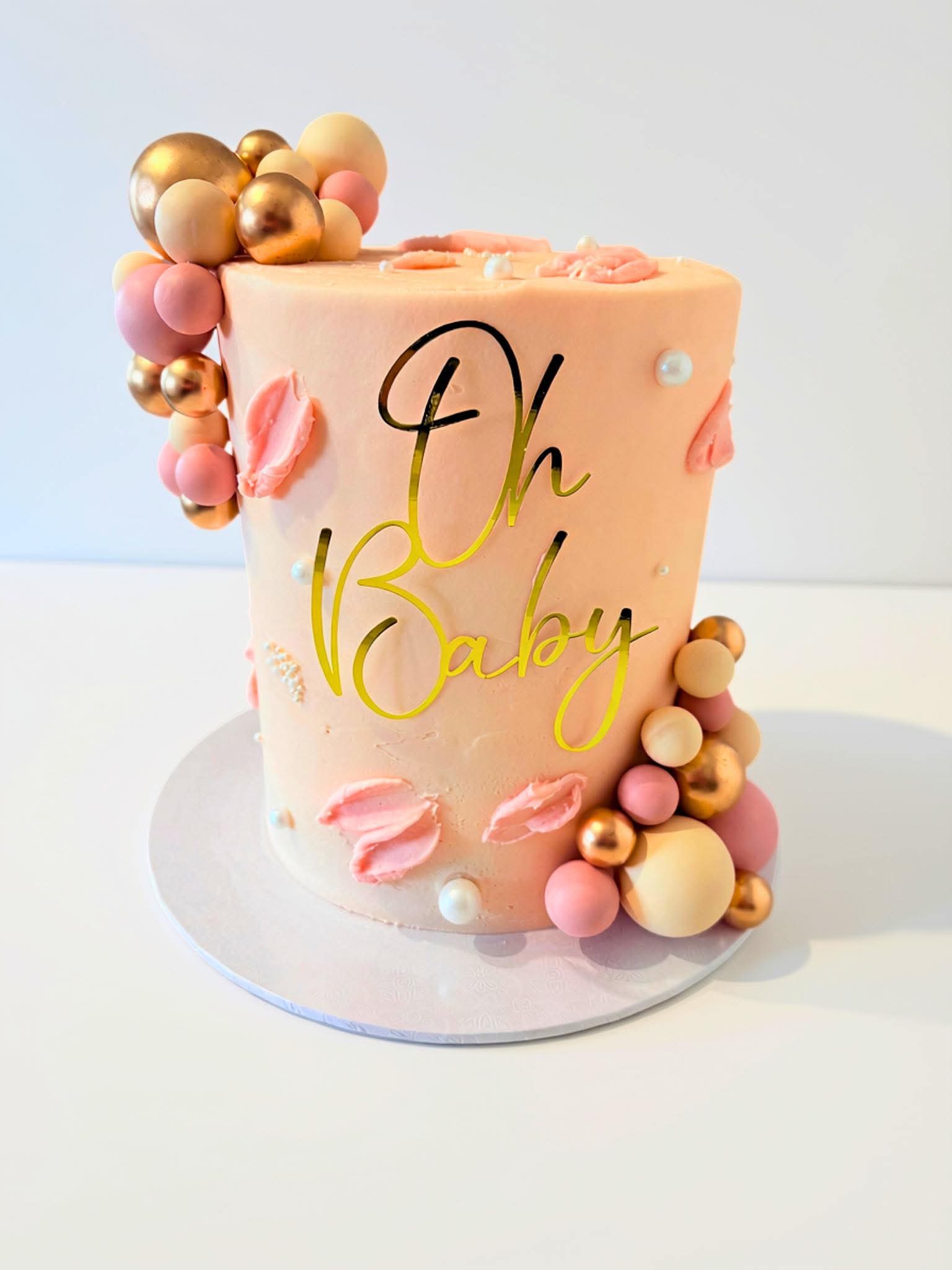 Pink and gold Oh Baby celebration cake by Cocoa & Crumbs
