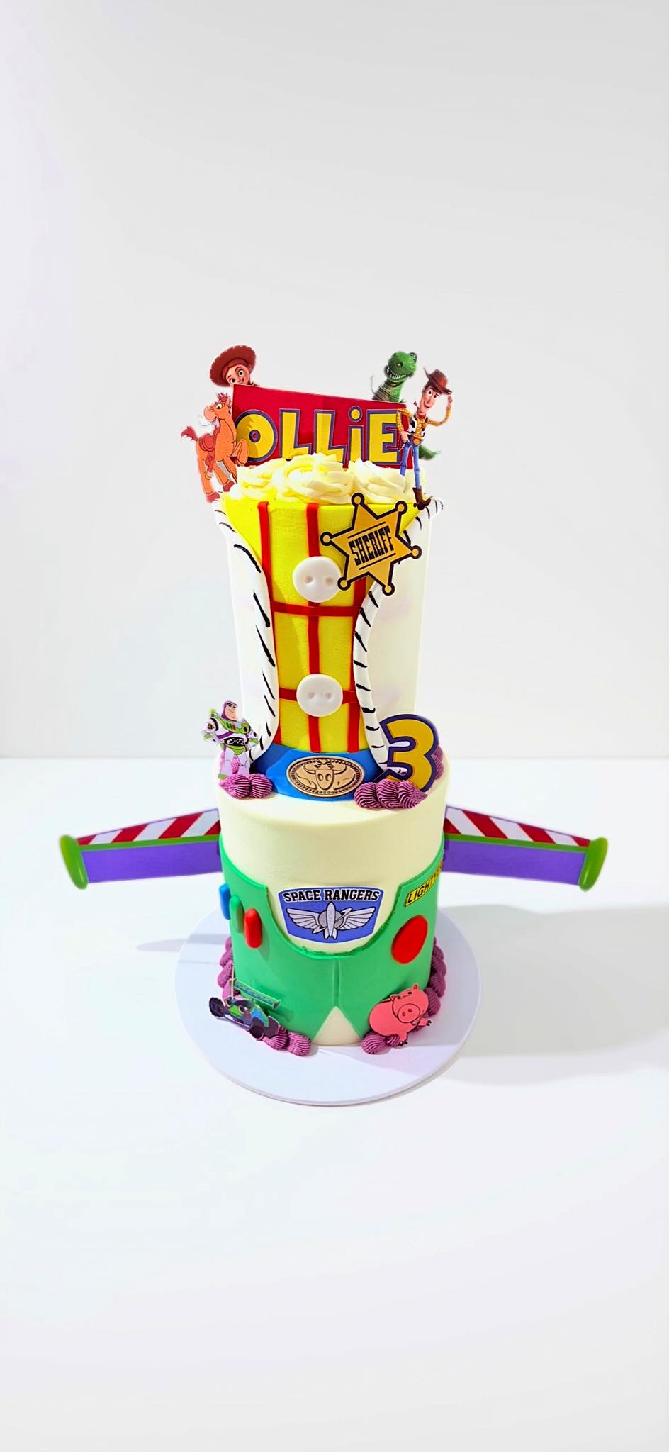 Two-tier Toy Story cake with Woody and Buzz Lightyear decorations
